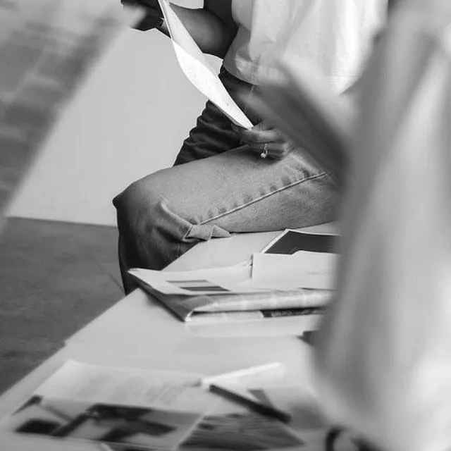 Persona revisando papeles y bocetos, proceso de creación de marca