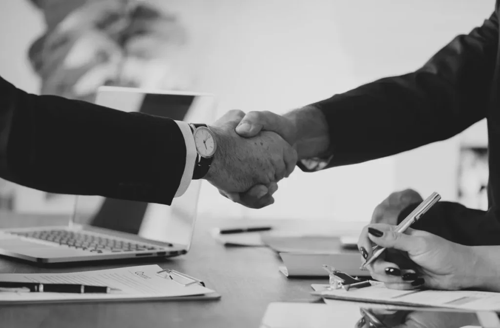 Apretón de manos en una reunión, acuerdos de patrocinio